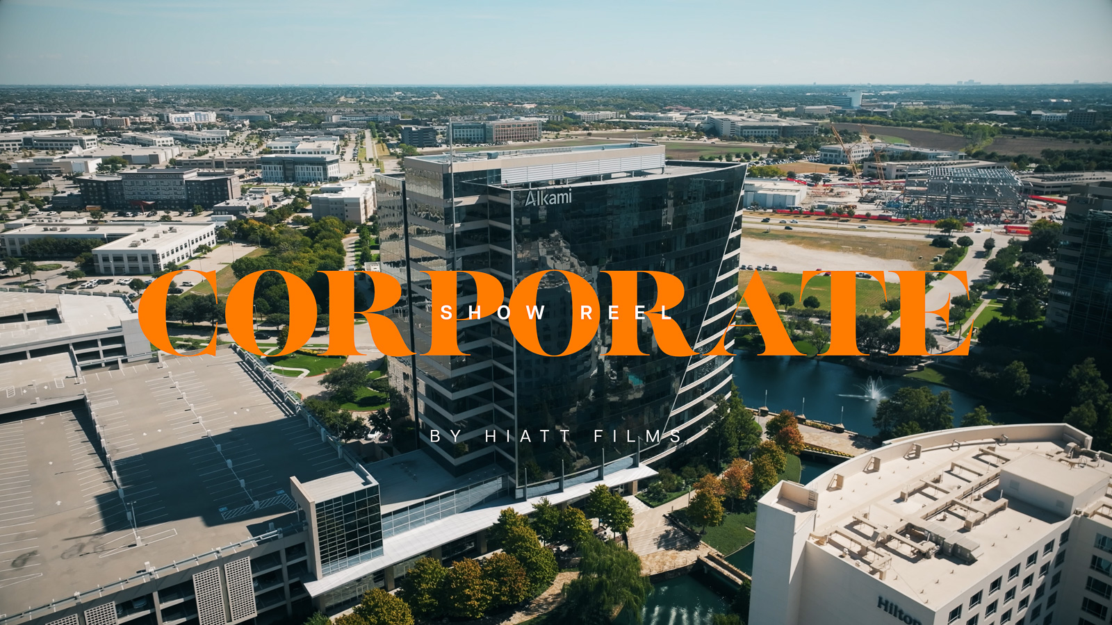 Corporate video show reel thumbnail featuring an aerial view of a modern office building