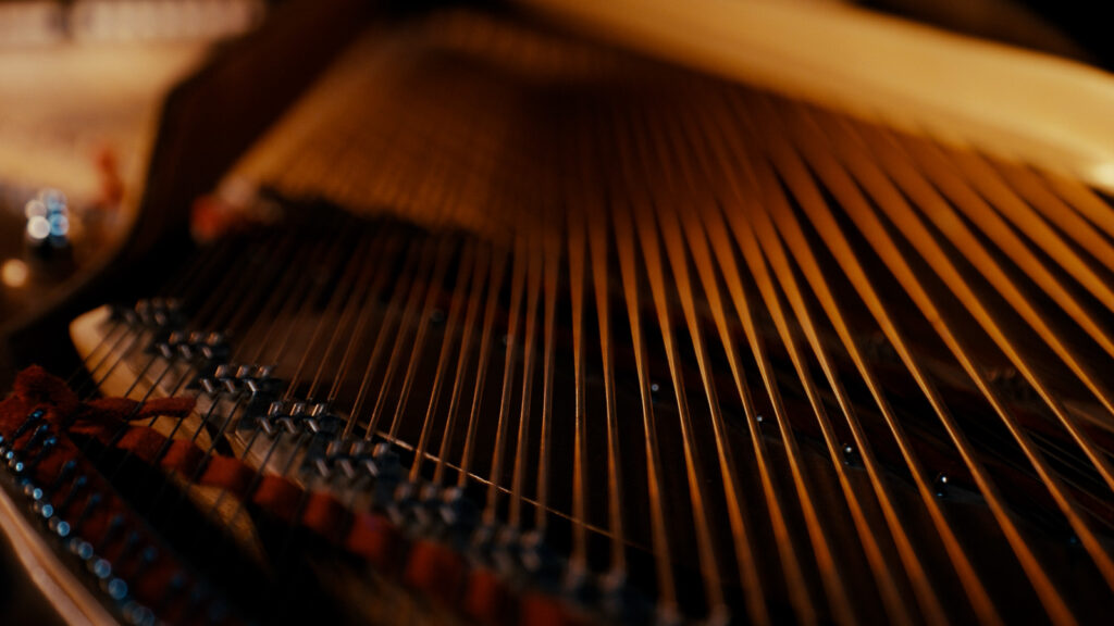 Close up of piano strings captured for cinematic detail shot during video production