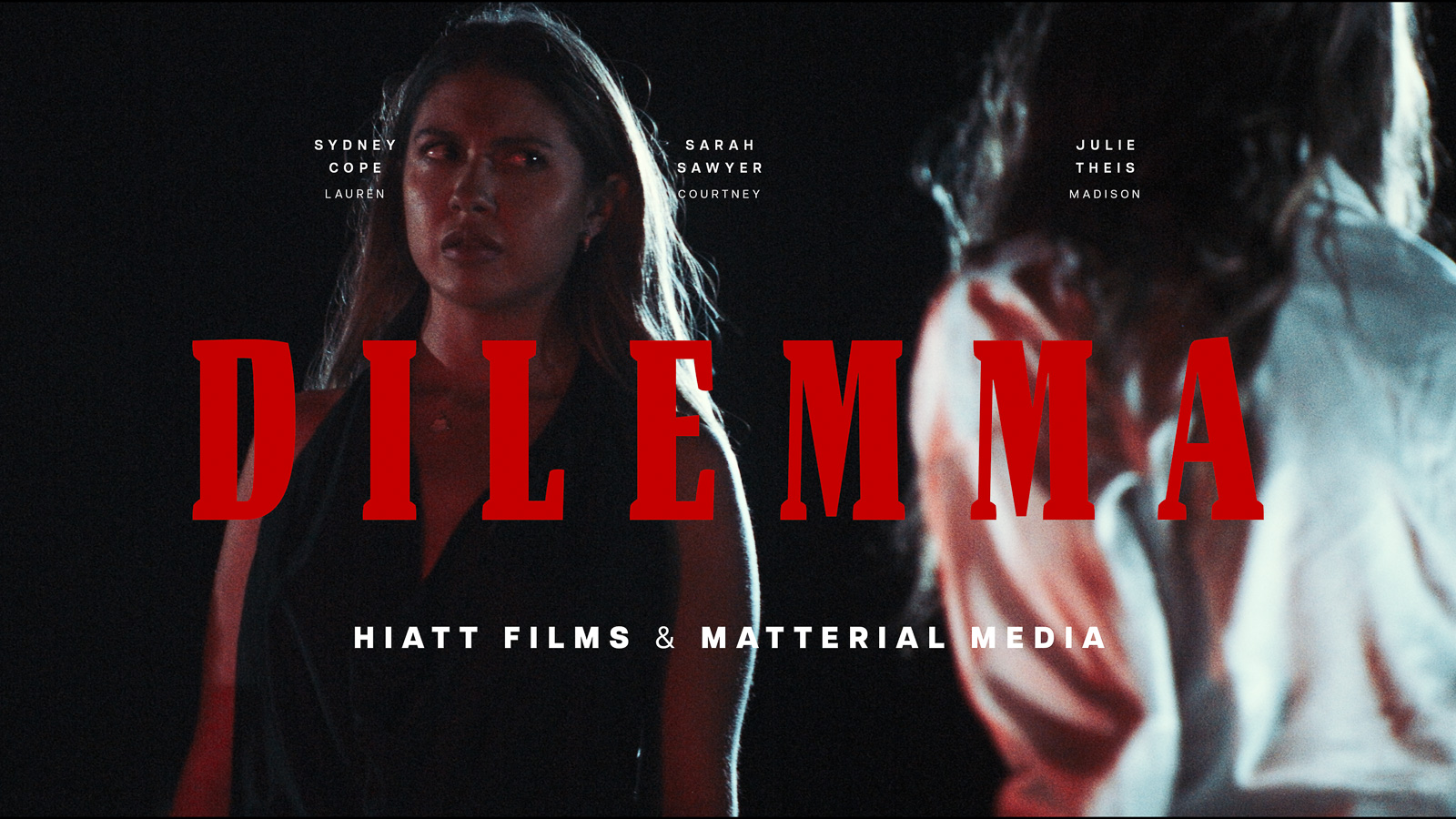 Dramatic narrative film scene featuring two women in tense low light environment