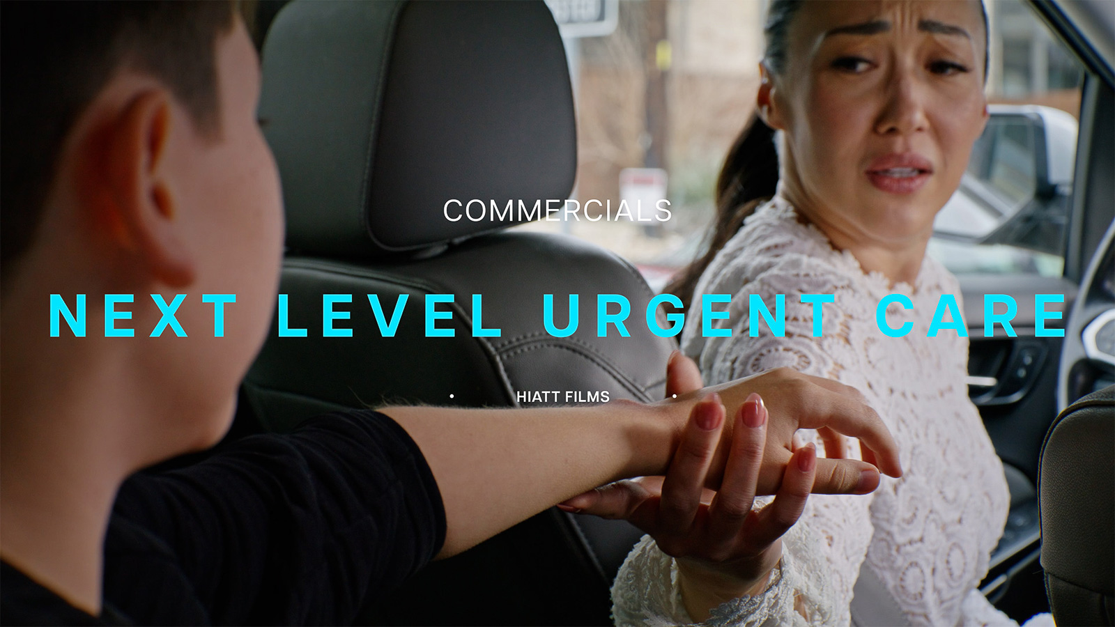 Cinematic commercial scene of a woman assisting an injured passenger inside a vehicle filmed by Hiatt Films