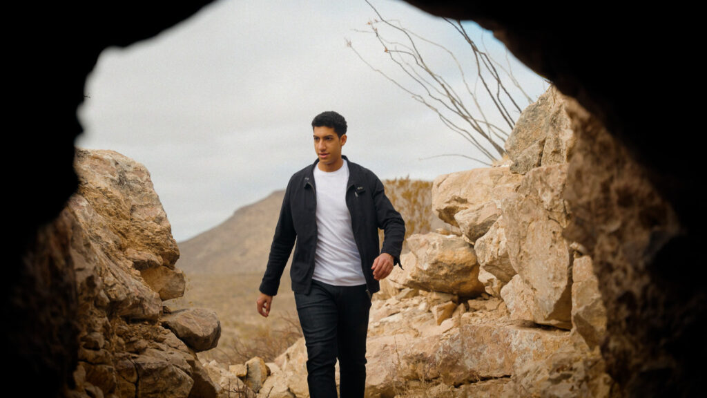 Cinematic video thumbnail of man walking through rocky desert passage