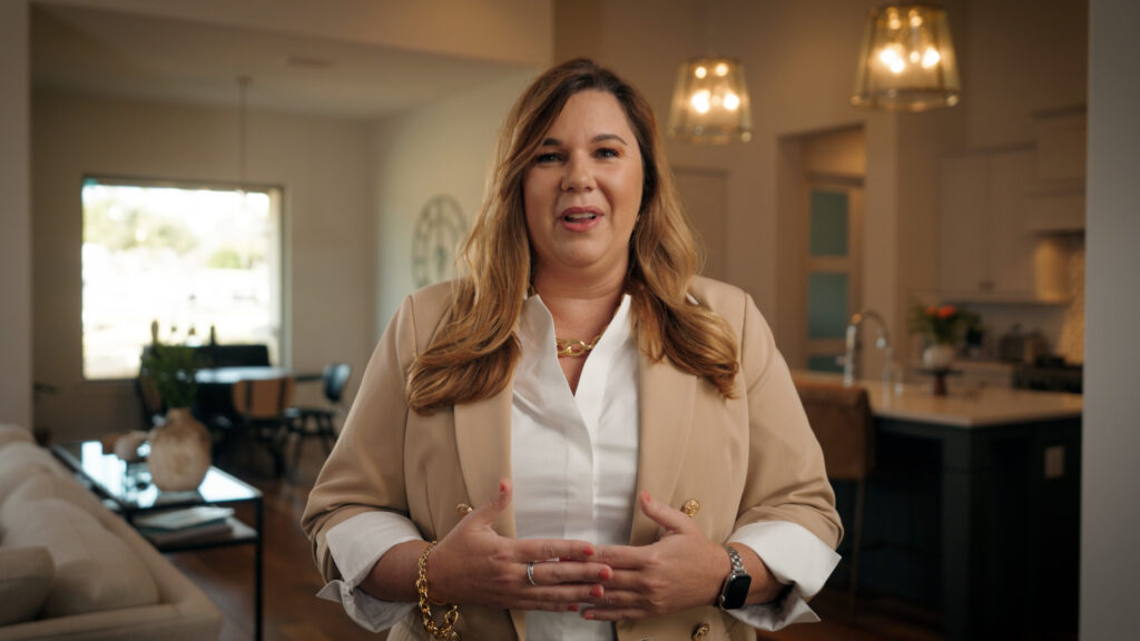 Professional woman speaking during corporate interview video in modern home setting